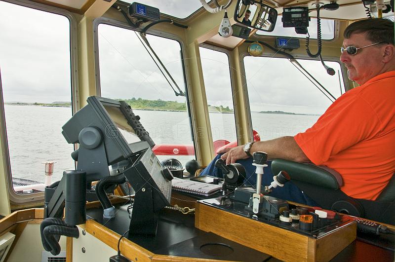 Master of the tugboat 'Liberty' guides his ship out of Boston harbor.