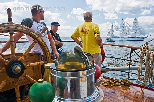 Captain and crew watch the tallship 'Sagres' from the quarterdeck of the 3 masted barque 'Picton Castle'.