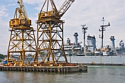 Dockside cranes in front of preserved battleship USS Salem.