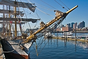 Bows and rigging of the barque 'Picton Castle' against a background of Boston Harbor.