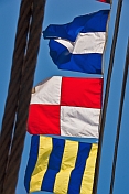 Colorful signal flags on rigging of the Russian square-rigger 'Kruzenshtern'.