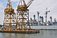 Image of Dockside cranes in front of preserved battleship USS Salem.