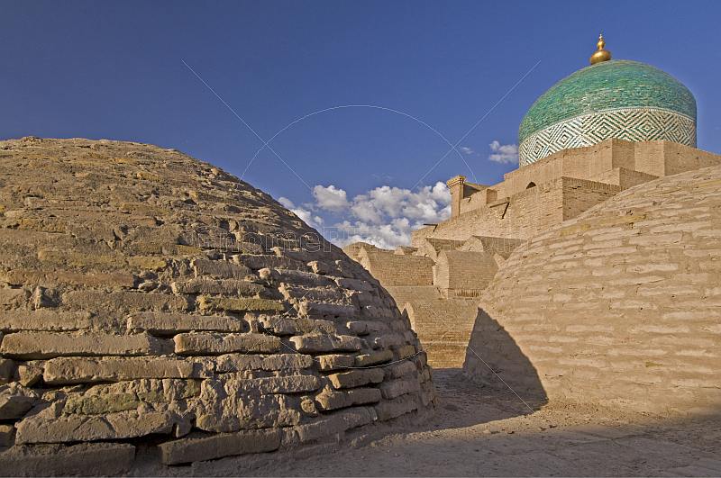 Early morning sunshine lights the brick domes of the Bathhouse of Anush-Khan.