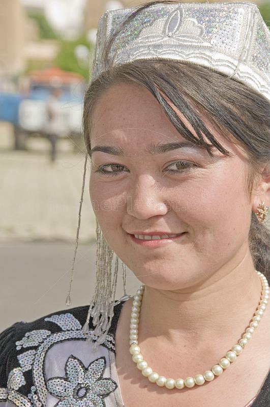 Uzbek lady in local dress poses near the tomb of Timur.