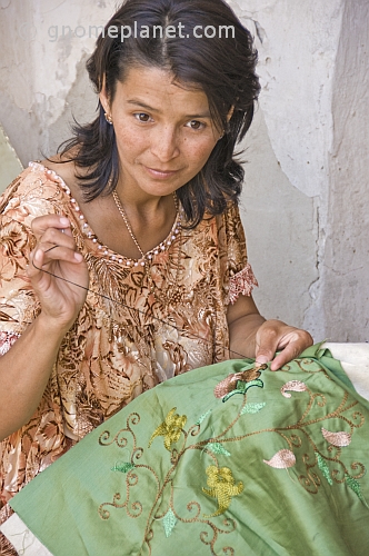 Craftswoman demonstrates her skill with embroidery.