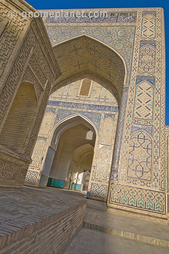 Blue ceramic tilework reflects the sunlight on the arch of the Kalyan Mosque.