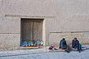 Two Uzbek traders wait for customers to visit their display of ceramics.