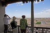 Tourists view the ancient buildings of the Khiva skyline from the roof of the Kuhna Ark.