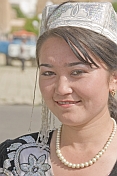 Uzbek lady in local dress poses near the tomb of Timur.