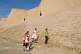 Image of Schoolgirls walk in front of the city walls.