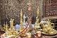 Carpets, rugs, brass-work, silver coffee sets, and water pipes for sale in bazaar.