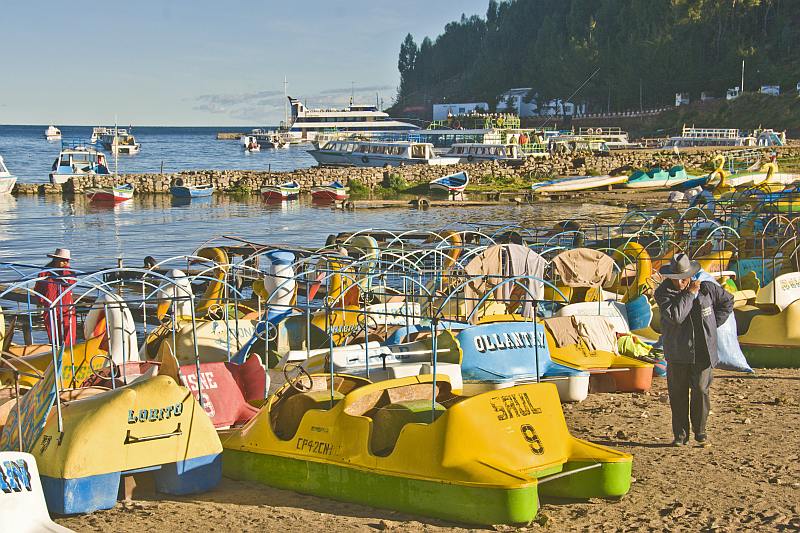 A jumble of pedalos pulled up on the beach of Lake Titicaca.