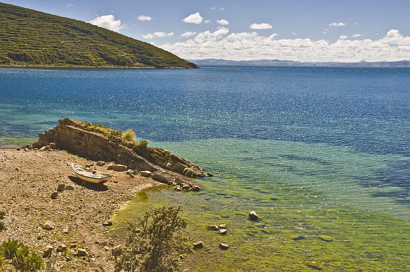 Boat pulled up on deserted beach on the Isla del Sol in Lake Titicaca.
