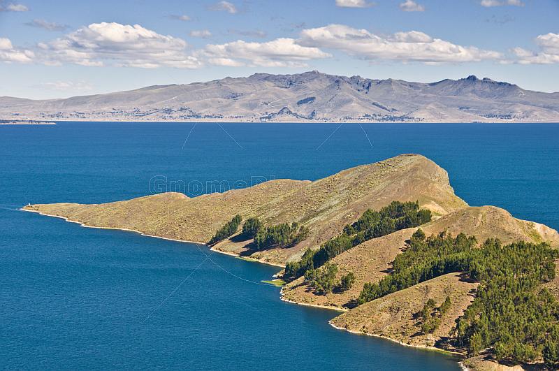 Trees and barren peninsula on the Isla del Sol in Lake Titicaca.