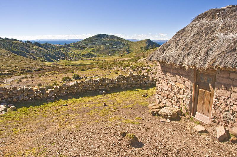Thatched stone house and terraced farmland on the Isla del Sol in Lake Titicaca.