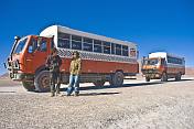 Two Dragoman Overland trucks and their drivers.