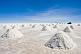 Image of Jeep stops to view piles of salt ready for collection at the Uyuni Salt Flats.