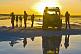 Image of Tourists with Land Rover viewing the sunset on the Uyuni Salt Flats.