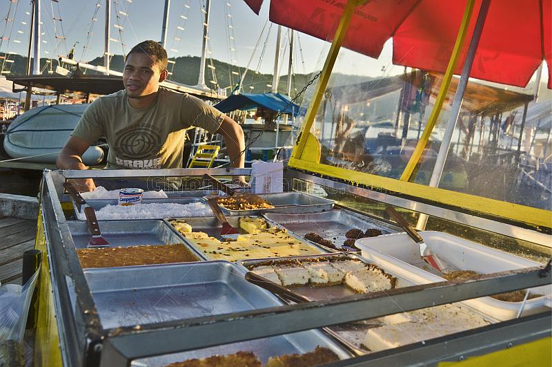 Cake vendor on the dock of Parati harbor.