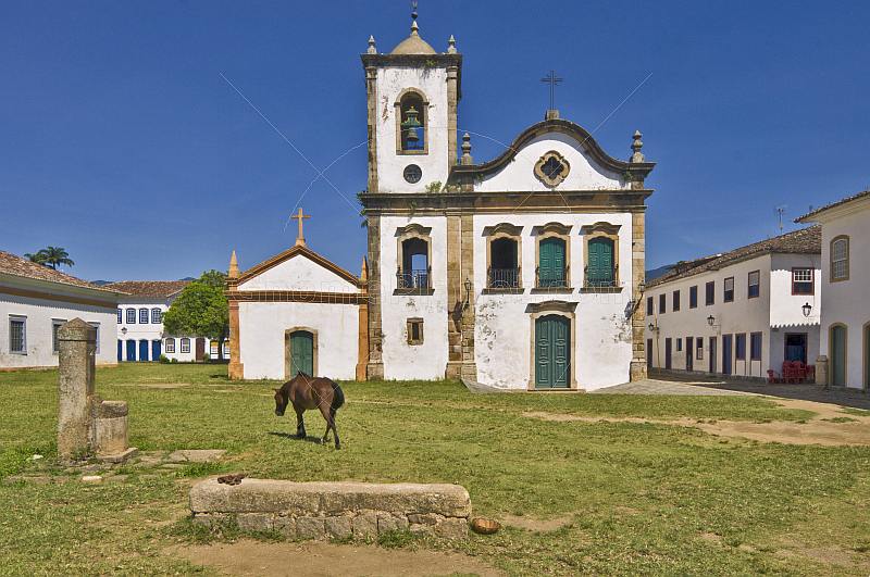 Horse grazes in front of the Igreja Santa Rita dos Pardos Libertos built in 1722.