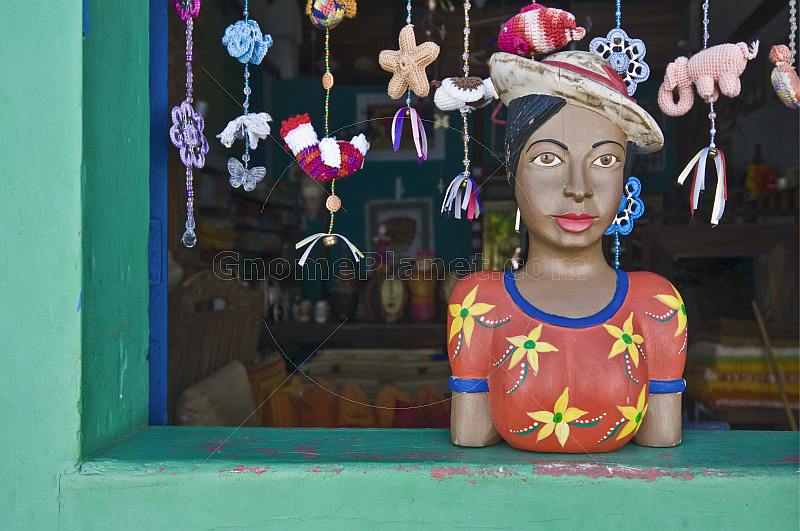Colorful store manikin in window of souvenir shop.