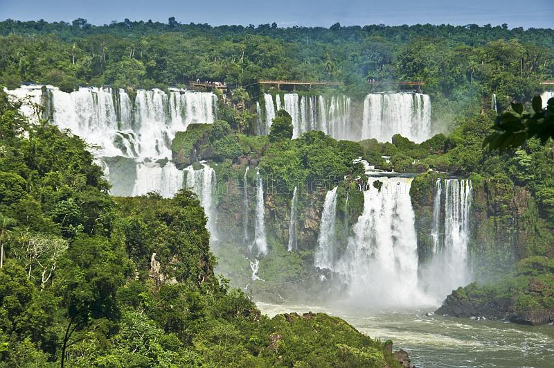Multiple waterfalls and jungle at the Iguazu Falls.