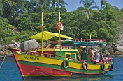 Colorful bathing boat in the waters of the Bahia Da Ilha Grande.