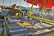 Cake vendor on the dock of Parati harbor.