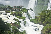Travellers admire the waterfalls at the Iguazu Falls.