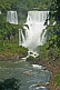 Inflatable boat approaches waterfall at the Iguazu Falls.