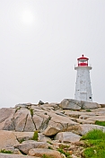 Sun struggles to shine on Peggy\\\\'s Cove lighthouse tower.