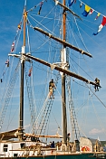 Crewmen work aloft on the rigging of the schooner 'Fair Jeanne'.