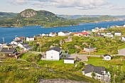 View over the town to the ocean inlet with coniferous forests and mountains.