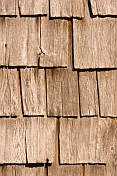 Detail of an ancient wooden shingled barn wall.