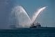 Image of The tugboat 'Atlantic Oak' shows off its fire fighting spray in Halifax harbor.