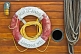 Image of Lifebelt porthole and rope contrast the deckhouse planking on the schooner 'Mist of Avalon'.