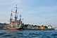 Image of Replica pirate ship \\\\'Hector\\\\' moored to the Pictou wharf alongside colonial style buildings.