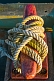 Image of Red dock mooring bollard with white rope in early morning sunlight.