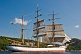 Image of Crew climb the masts and unfurl sail as the square rigger 'Picton Castle' journeys towards the ocean.