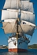 The tallship 'Picton Castle' leaves harbor on a sunny morning under full sail.