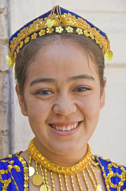 Smiling Uighur girl in local dress.