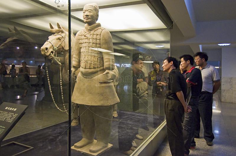 Chinese visitors admire a Terracotta Soldier and horse.