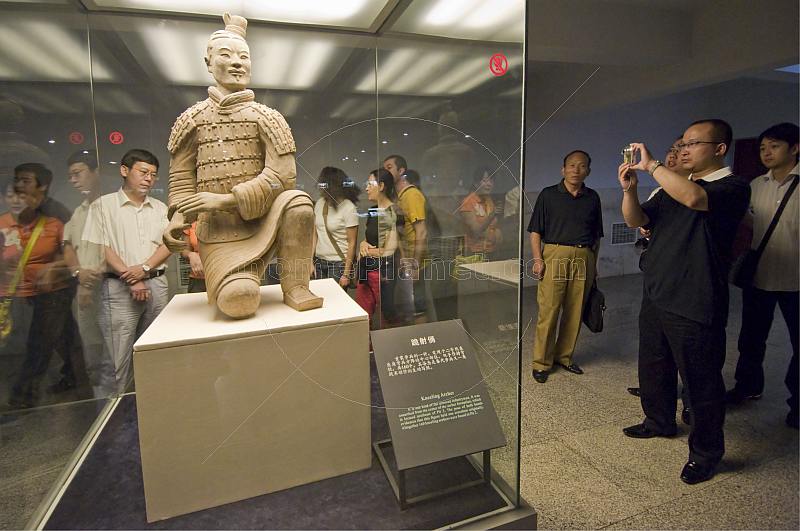 Chinese visitors admire a kneeling Terracotta Archer.