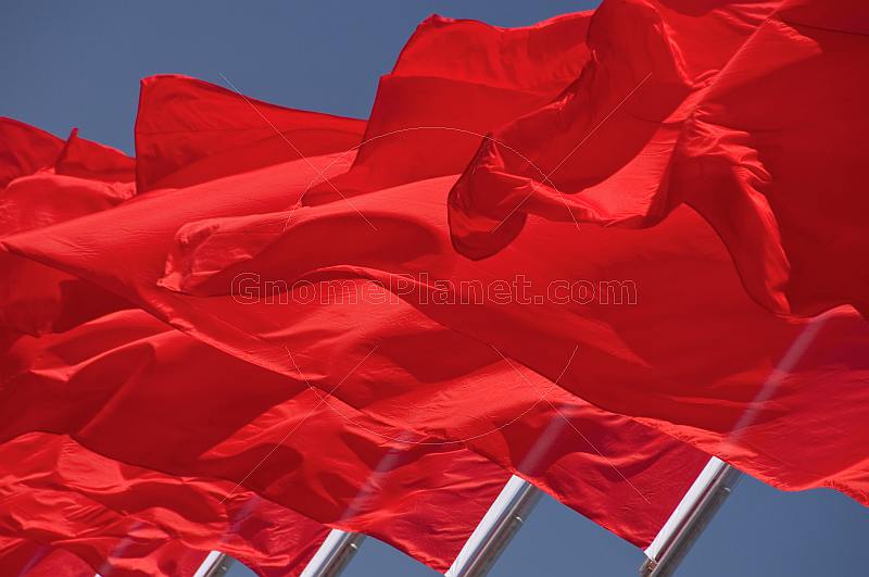 Red flags billowing in the wind of Tiananmen Square.