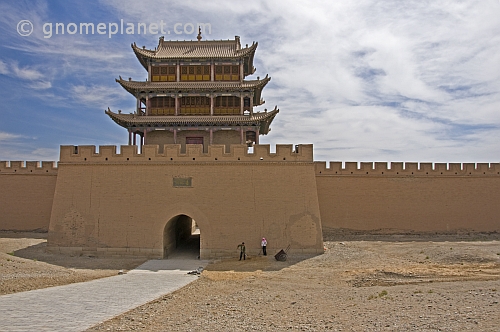 Two workers repair the paths in front of the main gateway to the Jiayuguan Fort.