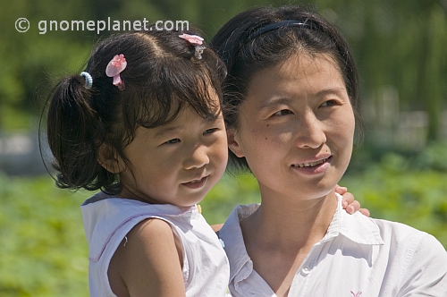 Chinese woman and daughter, posing next to Beihai Lake, in Beihai Park.