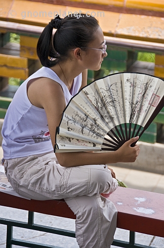 Chinese girl with white paper fan in Jingshan Park.
