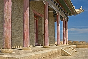 Red pillars and elaborate paintwork on a Pagoda-style watch tower at the Jiayuguan Fort.
