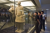Chinese visitors admire a Terracotta Soldier and horse.