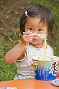 Young girl eating noodles at the Lily Lake of the Bishu Shanzhuang summer resort for Qing Emperors.